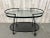 Modernist iron bar cart made by Woodard patio furniture company. Maintains it's original pebble glass with new powder coat...