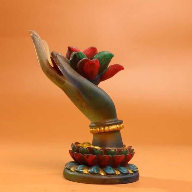 This vintage sculpture features a finely detailed hand holding a vibrant lotus blossom, crafted using the traditional...