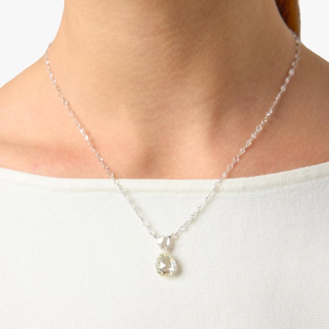 This exquisite Lugano drop necklace showcases a captivating 3.71 carat rose cut pear shape diamond, glowing with a soft,...