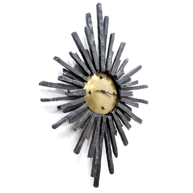This Mid century Brutalist wall clock was made in Germany during the 1960s. A very heavy clock made from cast iron and...