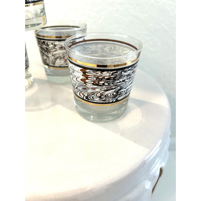 Cool set of four 1980's Anchor Hocking lowball glasses featuring a wide band in a swirl design in shades of white, blue,...