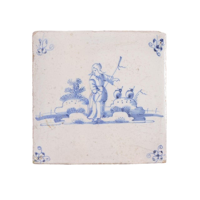 Set of six Delft faience tiles of figures in a landscape. The decorations are in underglaze cobalt blue with spider scroll...