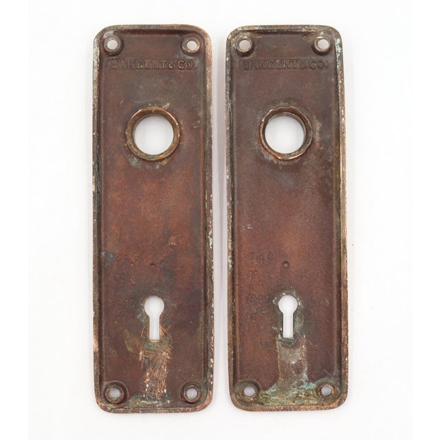 Classic pair of door back plates made of polished brass with a warm tone. Made by Sargent. The original mounting screws...