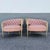 Glamorous pair of vintage French-inspired barrel chairs featuring softly curved silhouettes upholstered in blush pink...
