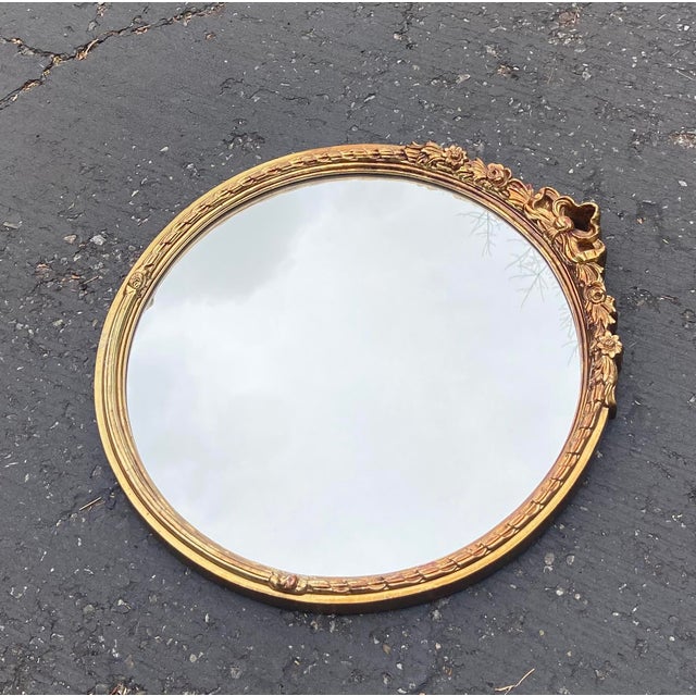 Vintage Carolina Mirror Company wall mirror, designed in the Hollywood Regency style. It features a round shape...