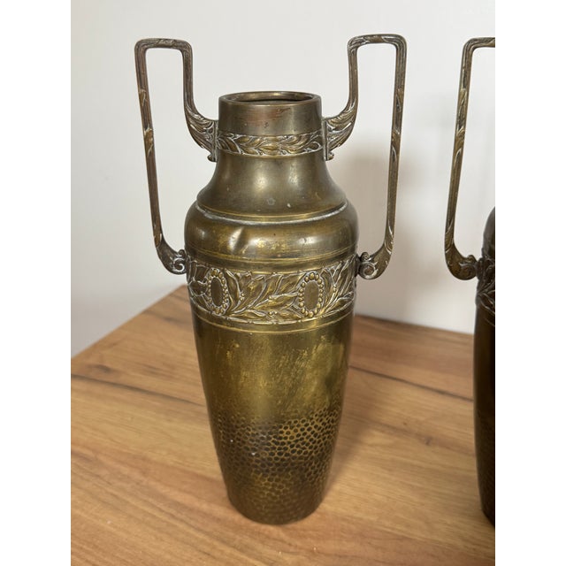 A set of two vintage brass vases or amphorae, in the Art Nouveau or Art Deco style, dating from the early 20th century....
