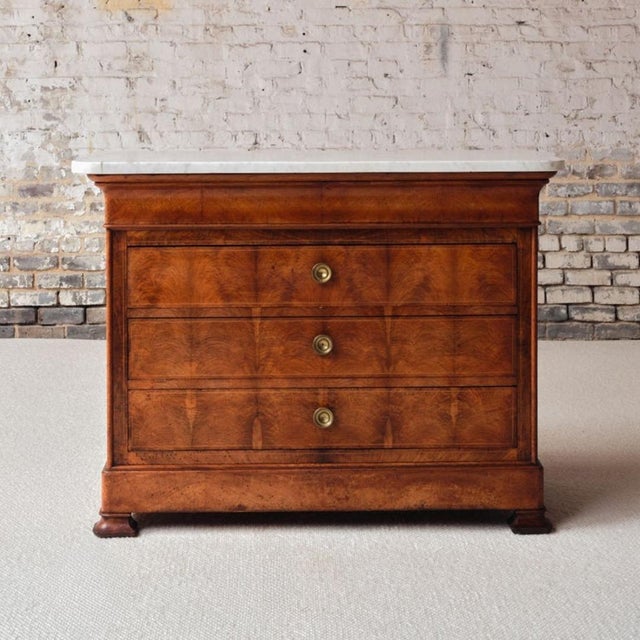 Add timeless elegance to your space with this French Louis Philippe style walnut marble top commode, circa 1960, a...