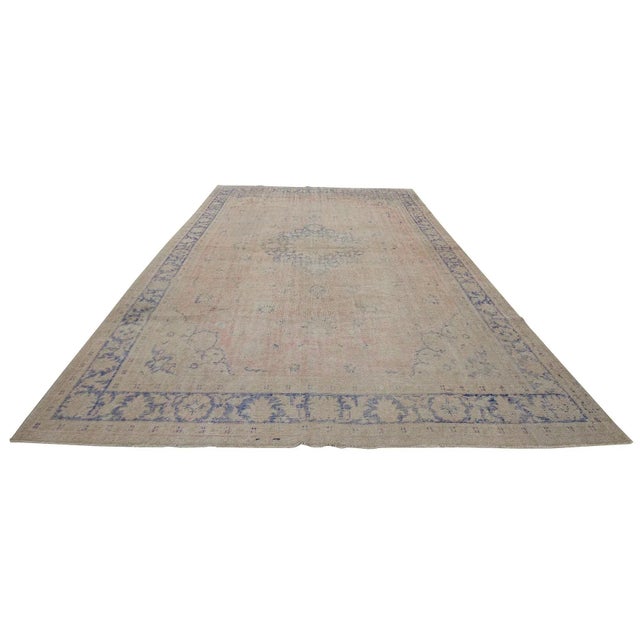 Distressed vintage handknotted rug from Oushak region of Turkey. Approximately 55-65 years old. In very good condition.
