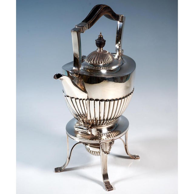 Elegant silver teapot with typical queen anne decoration: oval-bellied body, curved lines, semi-godronated walls, offset...