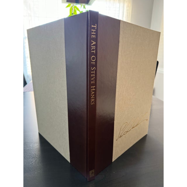 Hard cover limited edition book #600/2500 signed and numbered with book sleeve. The Art of Steve Hanks - Poised Between...