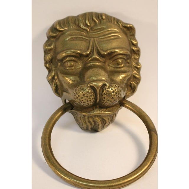 This lion head shaped door knocker is an impressive piece of solid brass dating from the mid 20th century. The door...