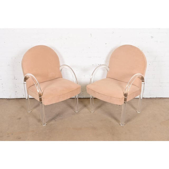 A gorgeous pair of Modern Art Deco or Mid-Century Modern lucite waterfall armchairs, club chairs, or lounge chairs By Leon...