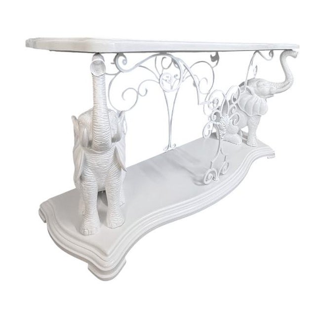This vintage elephant console table has been professionally refinished in a crisp white lacquer, highlighting its...
