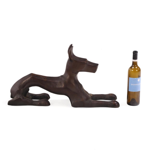 A striking French Modernist sculpture depicting a standing Great Dane, executed in cast bronze with a rich, dark...