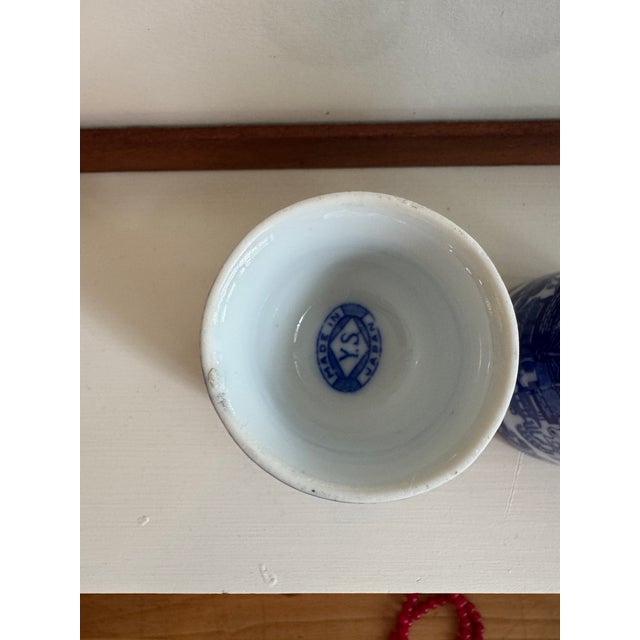 A vintage pair of porcelain egg cups in a Blue Willow transferware design. Both marked Y.S. Made in Japan. Excellent...