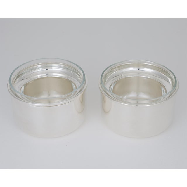A modernist silver plate and crystal caviar serving bowl duo—also suitable as chiller dishes—designed by renowned...