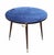 A refined and rare circular gaming table, made of wood with a top covered in a vibrant electric blue cloth. Along the edge...