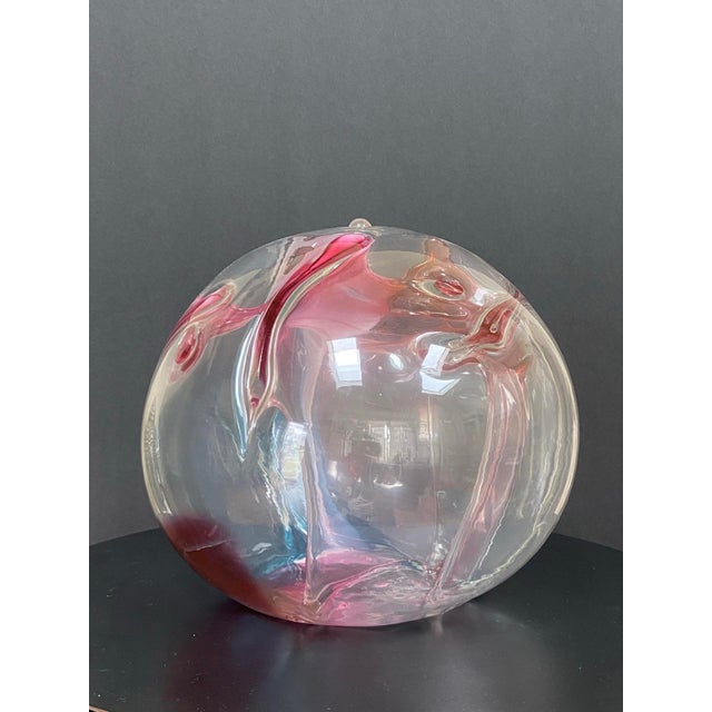 Contemporary studio art glass orb sculpture by Peter Bramhall, hand-blown with suspended interior “thread” elements in...