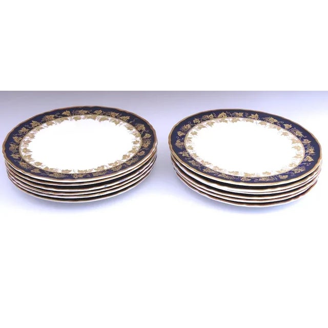 Set of 12 bread and butter plates by ROYAL WORCESTER. Blue with gold grape leaf motif. Pattern Arundel Blue (Scalloped)....