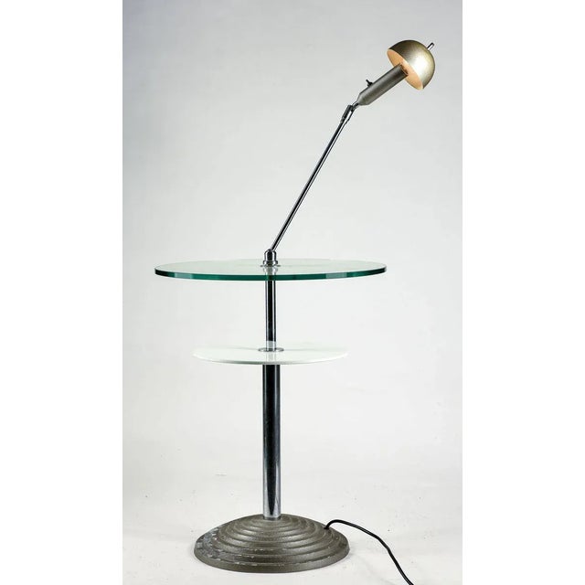 Reading table with jointed lamp and adjustable point of light. Made of silver metal with double top in clear glass and...