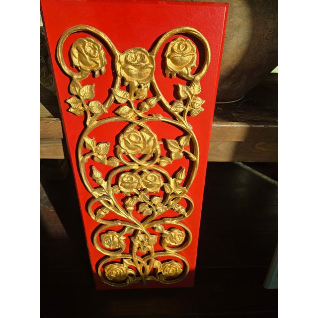 Metal sculpture on top of wood, backing