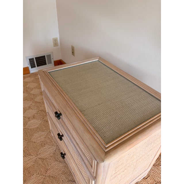 This is a three drawer nightstand from Ficks Reed. Good condition Glass top.