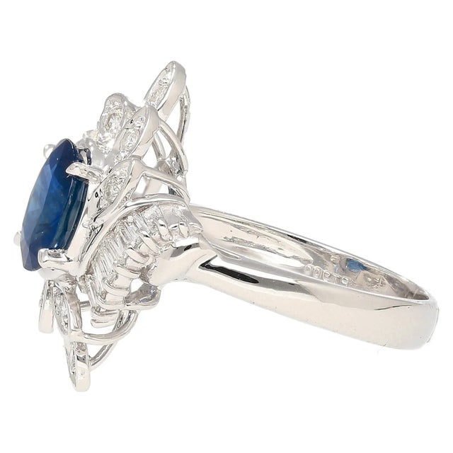 Natural Oval Cut Blue Sapphire and Diamond Platinum Floral Motif Ring. This cocktail ring is crafted from a platinum 900...