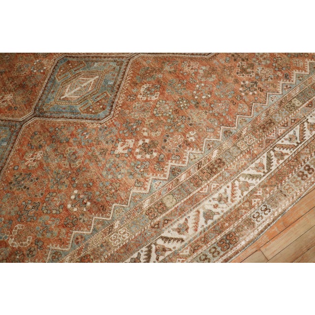 An early 20th century Persian Shiraz small room size tribal rug in earth tones circa 1920 Measures: 7'5" x 10'5".