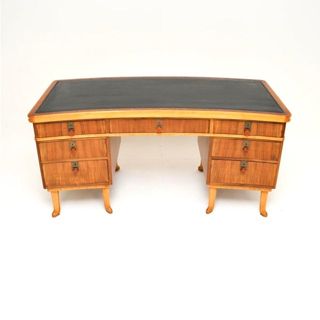 A spectacular vintage walnut pedestal desk by Laszlo Hoenig. This was made in London, there is a label beneath the top...