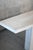 A bold and angular postmodern period travertine table. Tan with subtle variegation, fine beveled edges and a pedestal...