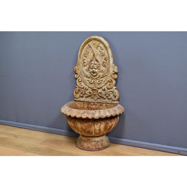 This cast iron fountain, dating from the early 20th century, is a true testament to the craftsmanship and attention to...