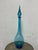 Design Plus Gallery presents a Blue Toned Hand Blown Vessel from Italy. The tall glass bottle has a smooth surface and a...