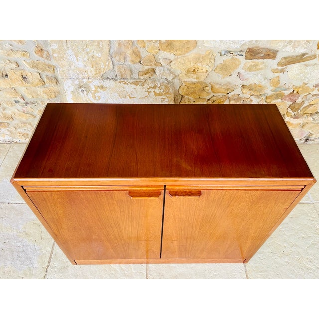 Vintage; small credenza/storage cabinet from high end furniture maker, hulsta circa 70s. piece is made of wood with a teak...