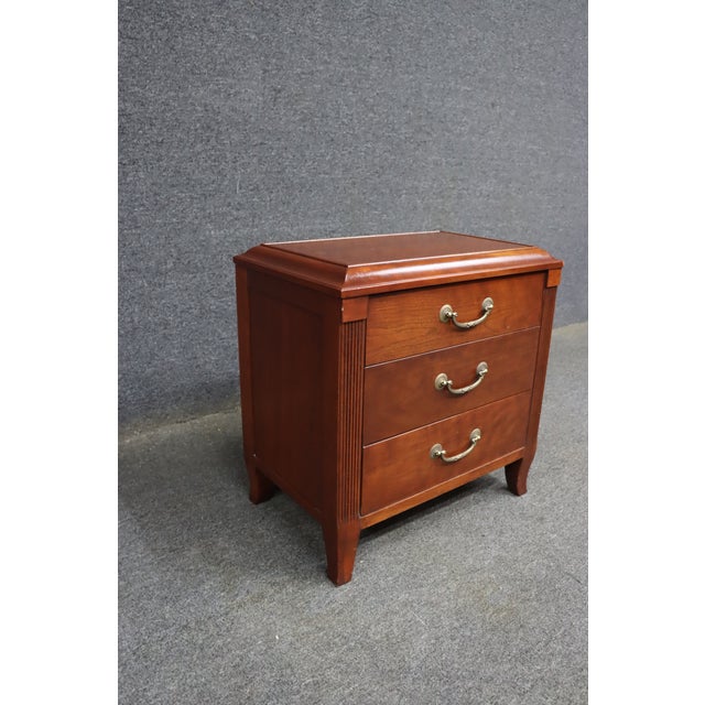 Ethan Allen Maison Collection three-drawer nightstand crafted from solid cherry. Features a molded rectangular top, three...