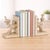 Add a warm, nature-inspired accent to your shelving with this bird on branch bookend set, featuring delicately sculpted...