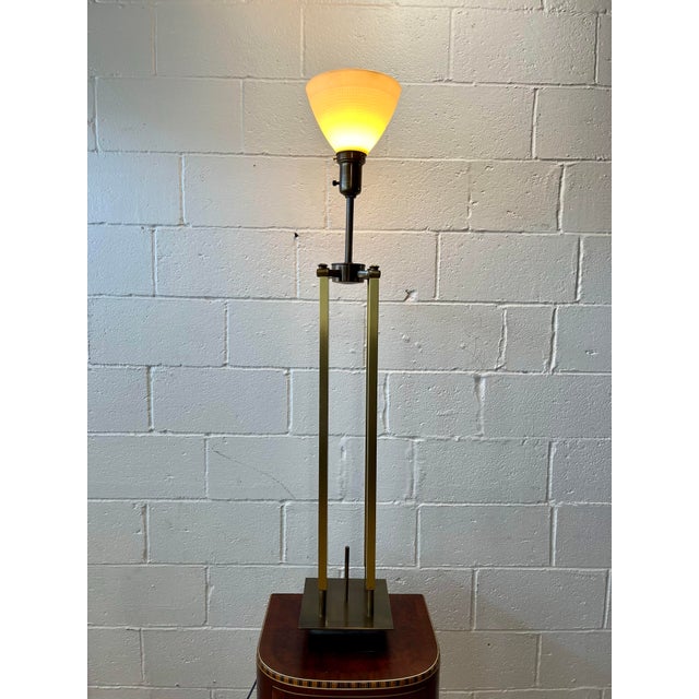 Wonderful towering lamp by Tommi Parzinger for Stiffel. Sleek and slender campaign cage design with knob final accent....