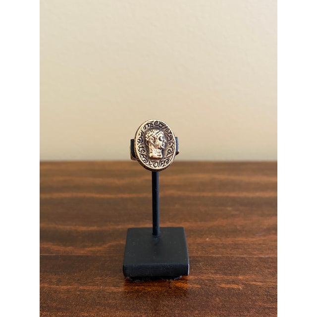 A remarkable ancient Roman bronze signet ring dating to the Imperial period, circa 200 AD, featuring an engraved oval...