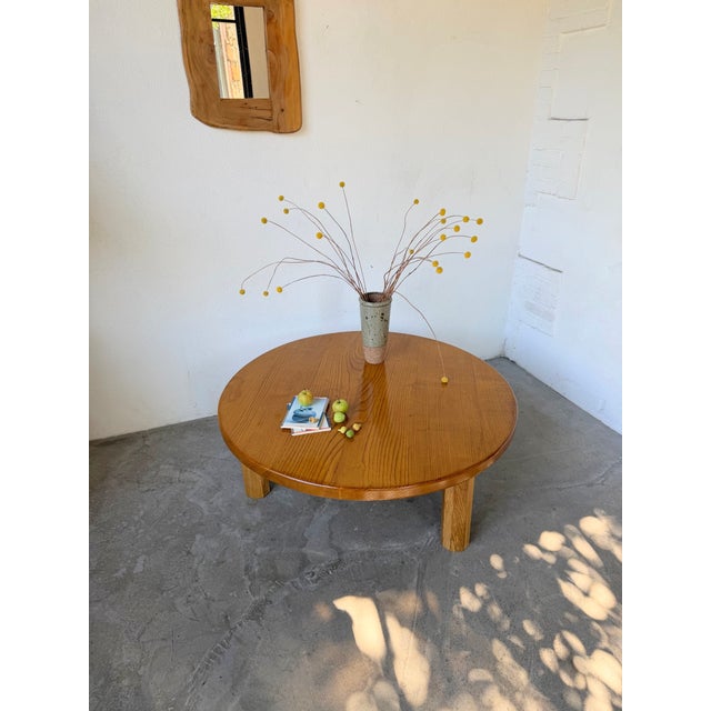 Vintage circular coffee table in solid oak, with a very thick top, resting on three hexagonal legs, inspired by the 1950s....