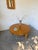 Vintage circular coffee table in solid oak, with a very thick top, resting on three hexagonal legs, inspired by the 1950s....