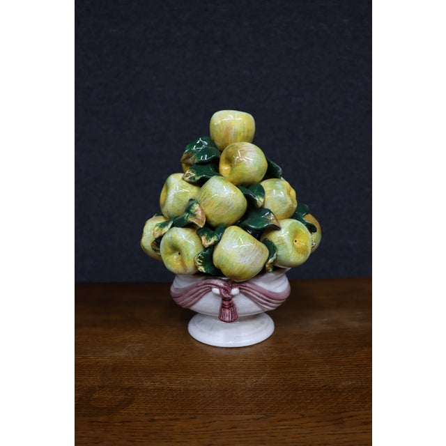 Large Italian ceramic fruit centerpiece featuring a piled arrangement of hand-modeled apples and leaves. The fruit is...