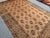 Welcome! This vintage Afghan hand-knotted tribal rug features a striking geometric design in warm brown and beige tones,...
