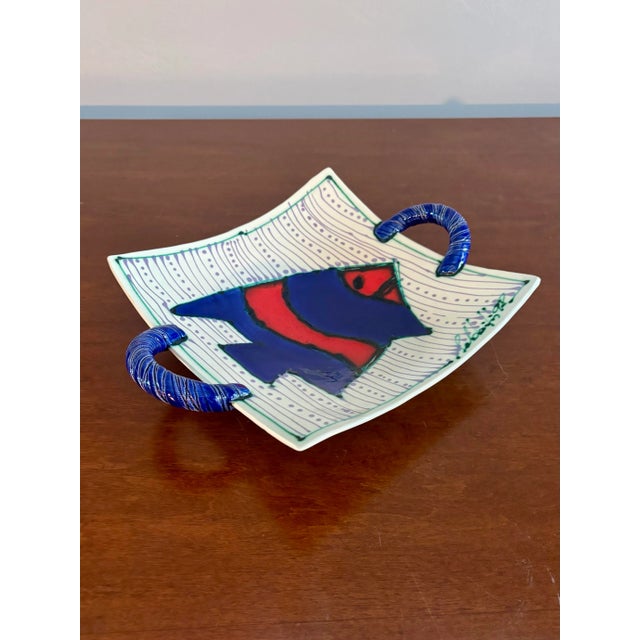 Beautiful ceramic serving plater. Red white and blue color profile with an expertly designed fish. Two handles and the...
