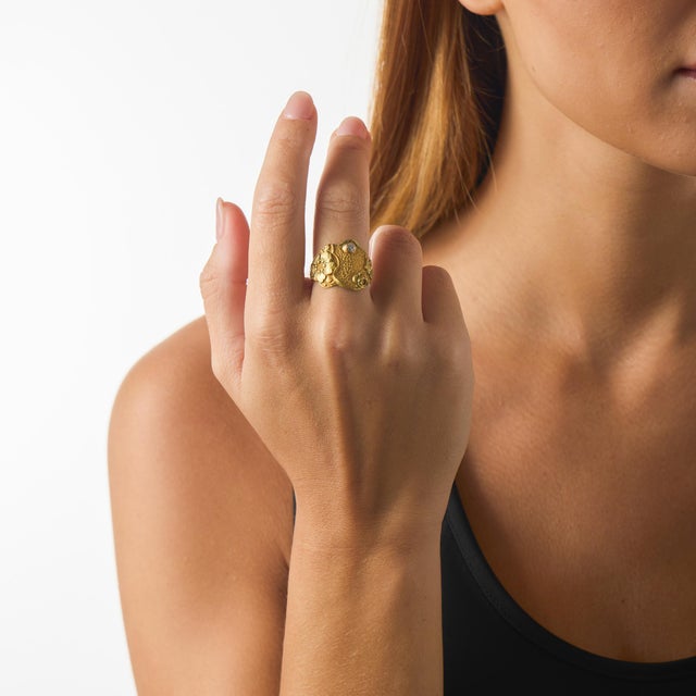 This authentic Art Nouveau ring showcases a delicate floral-inspired design centered on an old European cut diamond...