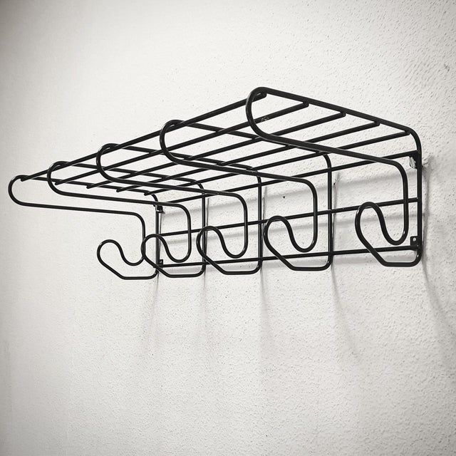 Wall-mounted coat, hat, and bag rack from the "Frän" series, produced by IKEA in Sweden in the 1980s. This coat rack, made...