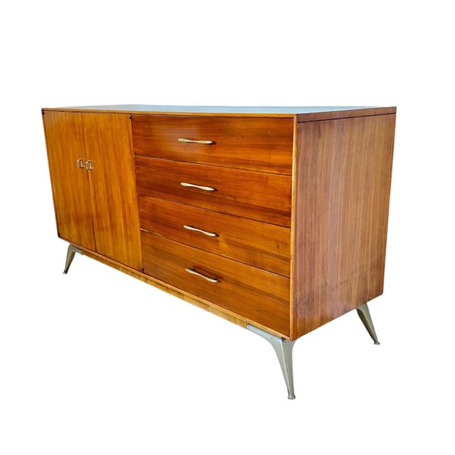 This vintage mid-century modern credenza by R-Way Furniture features a classic design, beautiful amber tone walnut wood...