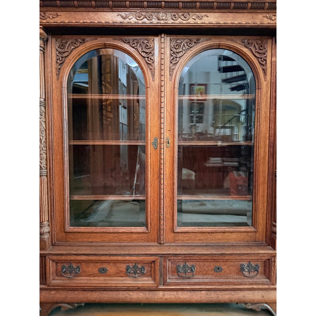 Late 19th Century Antique French Renaissance Revival carved oak bookcase. Constructed from solid oak with a medium to dark...