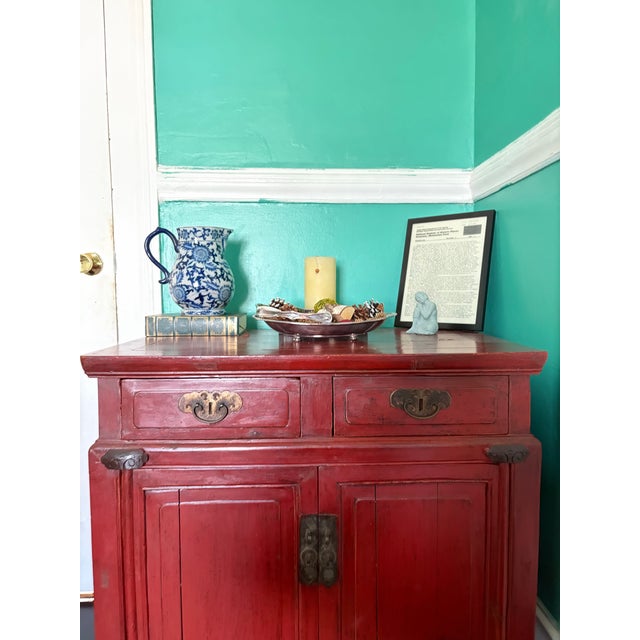Rich in color and restrained in form, this late Qing Dynasty red lacquer cabinet exemplifies the quiet elegance of...