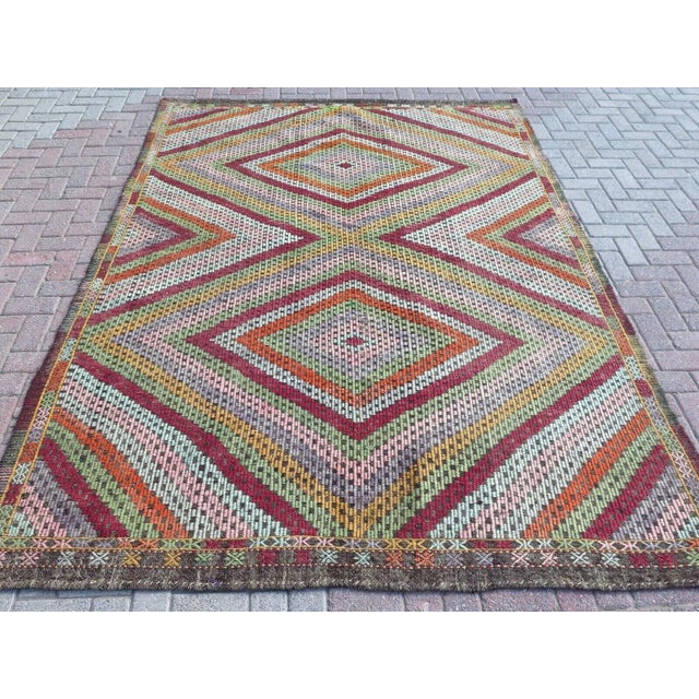 This beautiful, traditional vintage, flatweaved Turkish kilim rug is approximately 60 years old. It is handmade of very...