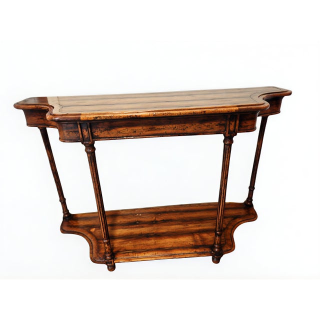 A stunning console table made of Pecan wood with stunning, understated, unique features. The wood has a rich, varied grain...