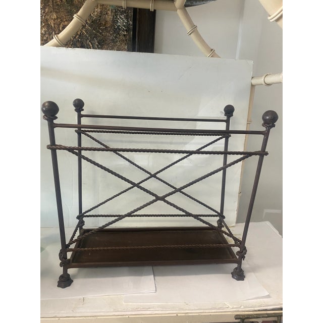 Beautiful magazine rack with rope and tassel detail in a dark metal finish. A great Hollywood Regency look that would also...